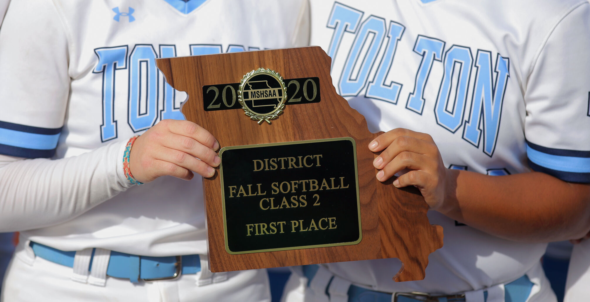 Tolton junior Emilee Farnan and freshman Eva Viox hold up the first-place plaque